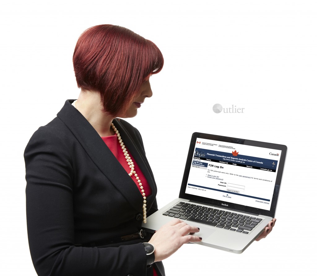 Amber looking at laptop FINTRAC screen